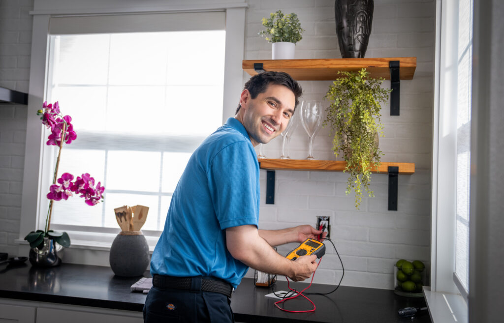 Ellington Electrician working on outlet