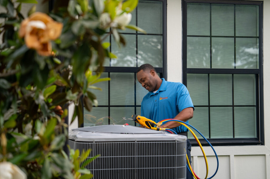 AC Installation Tech Working on Air Conditioning Unit