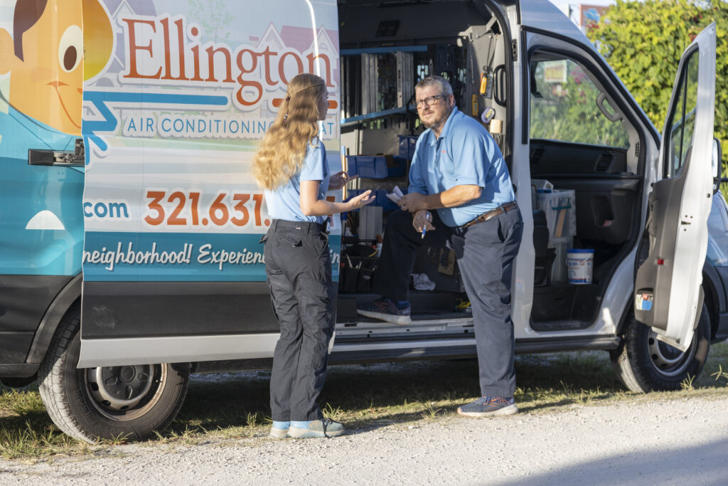 Ellington HVAC Tech Standing by Van with Customer