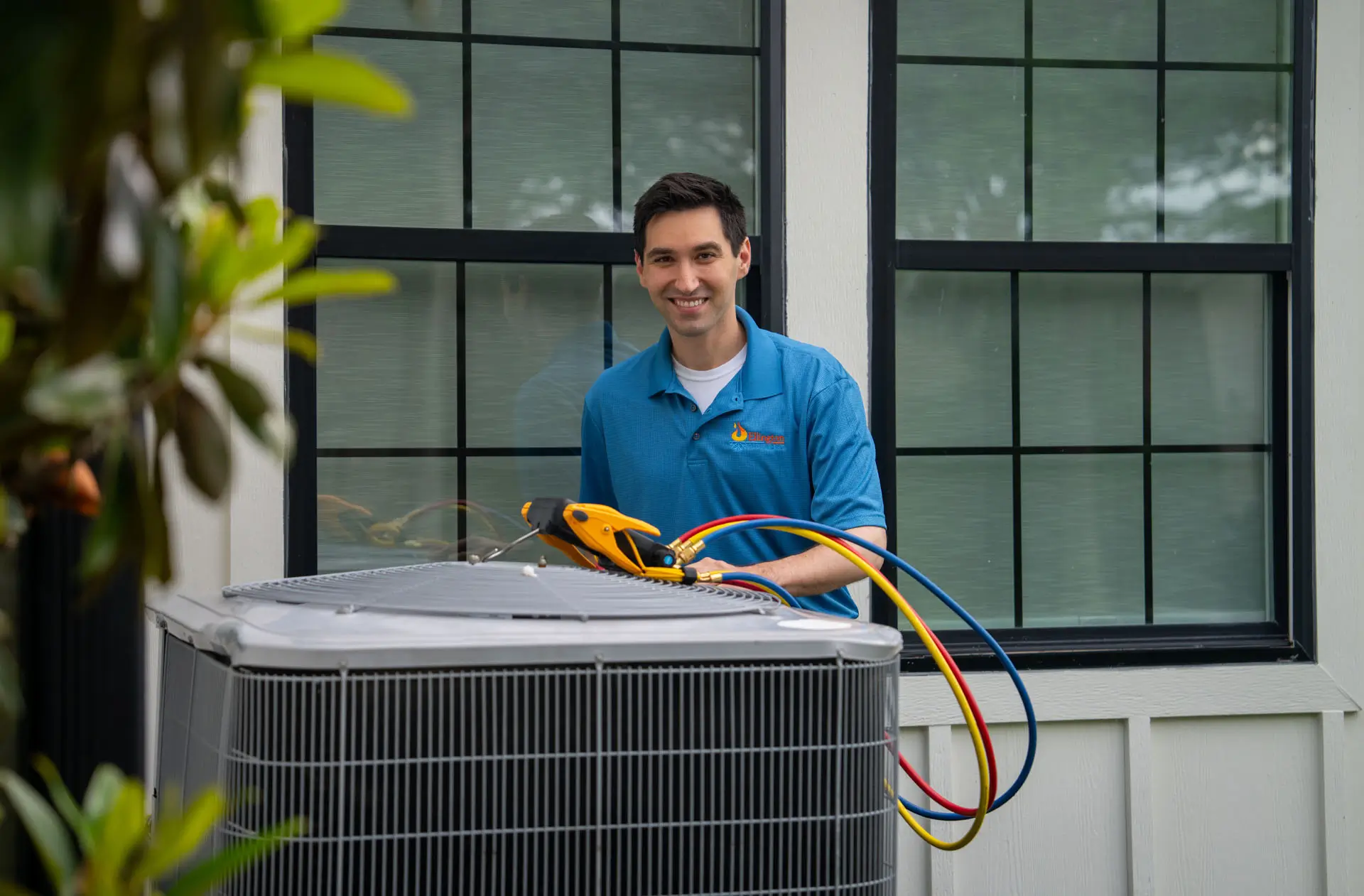 technician servicing outdoor hvac unit