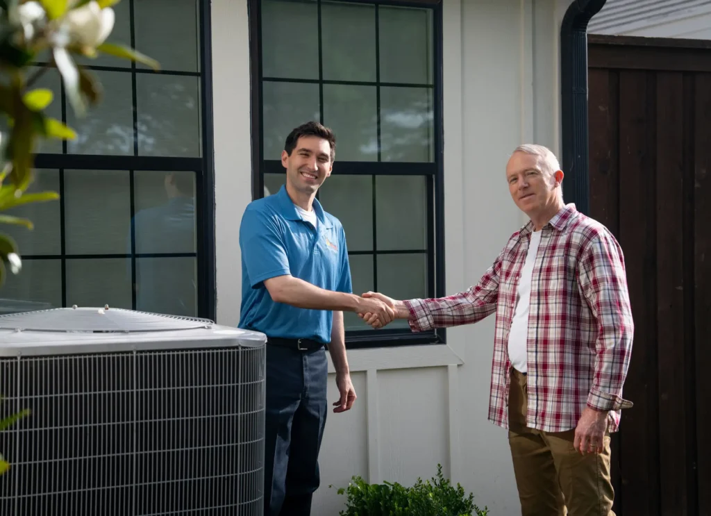 technician shking hands with customerf